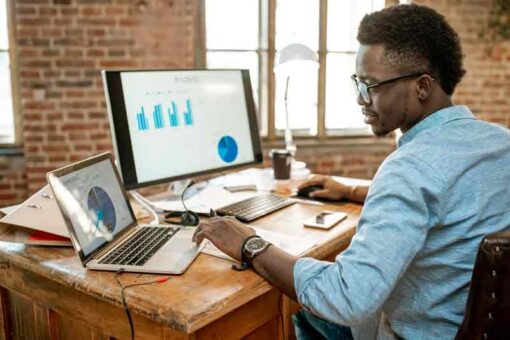 Man working at desk evaluating marketing analytics 